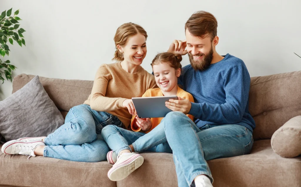 happy family looking at ipad