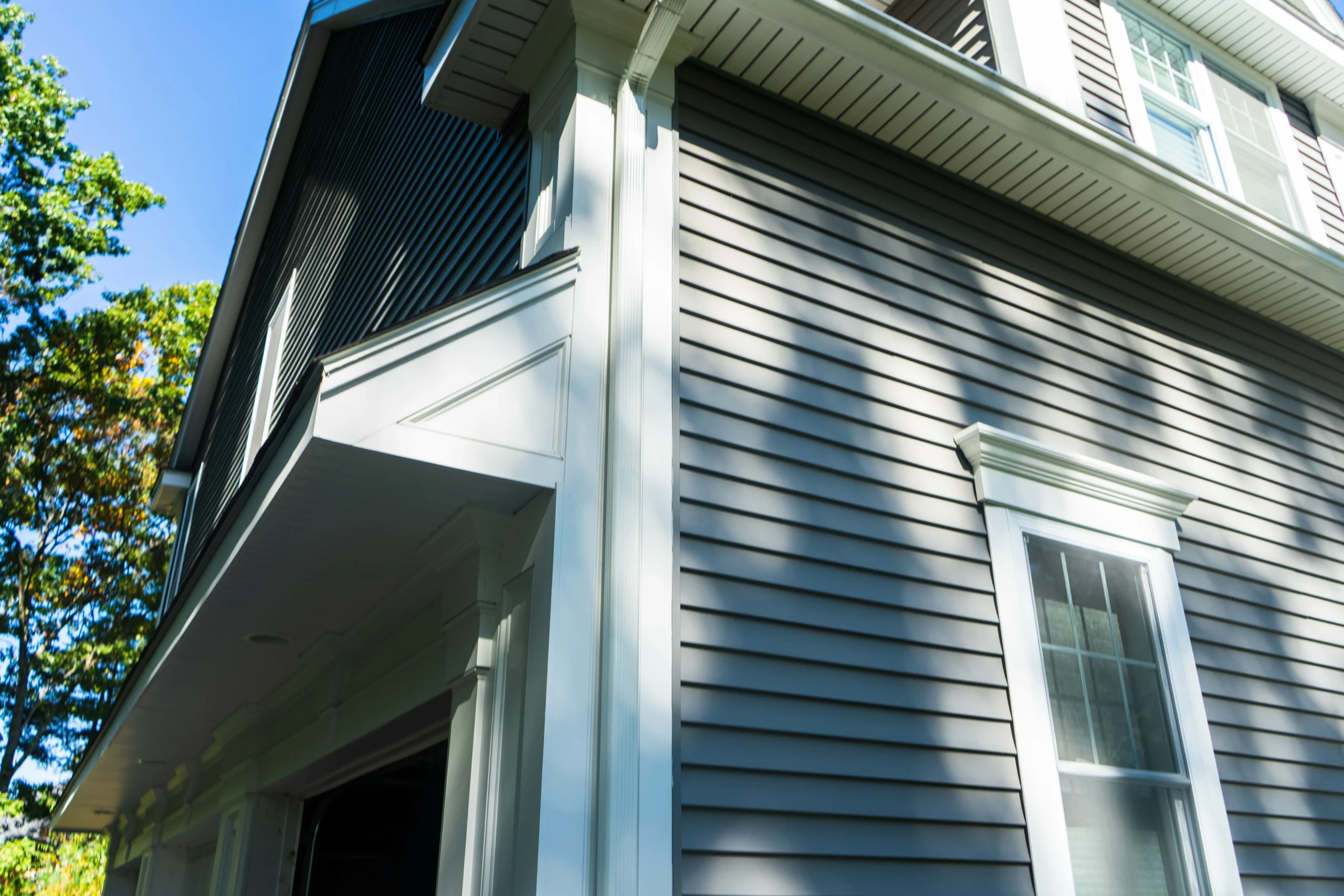 corner shot of house with grey siding and white trim