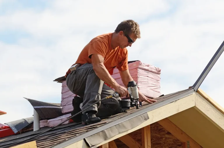 close up to roofer installing shingles