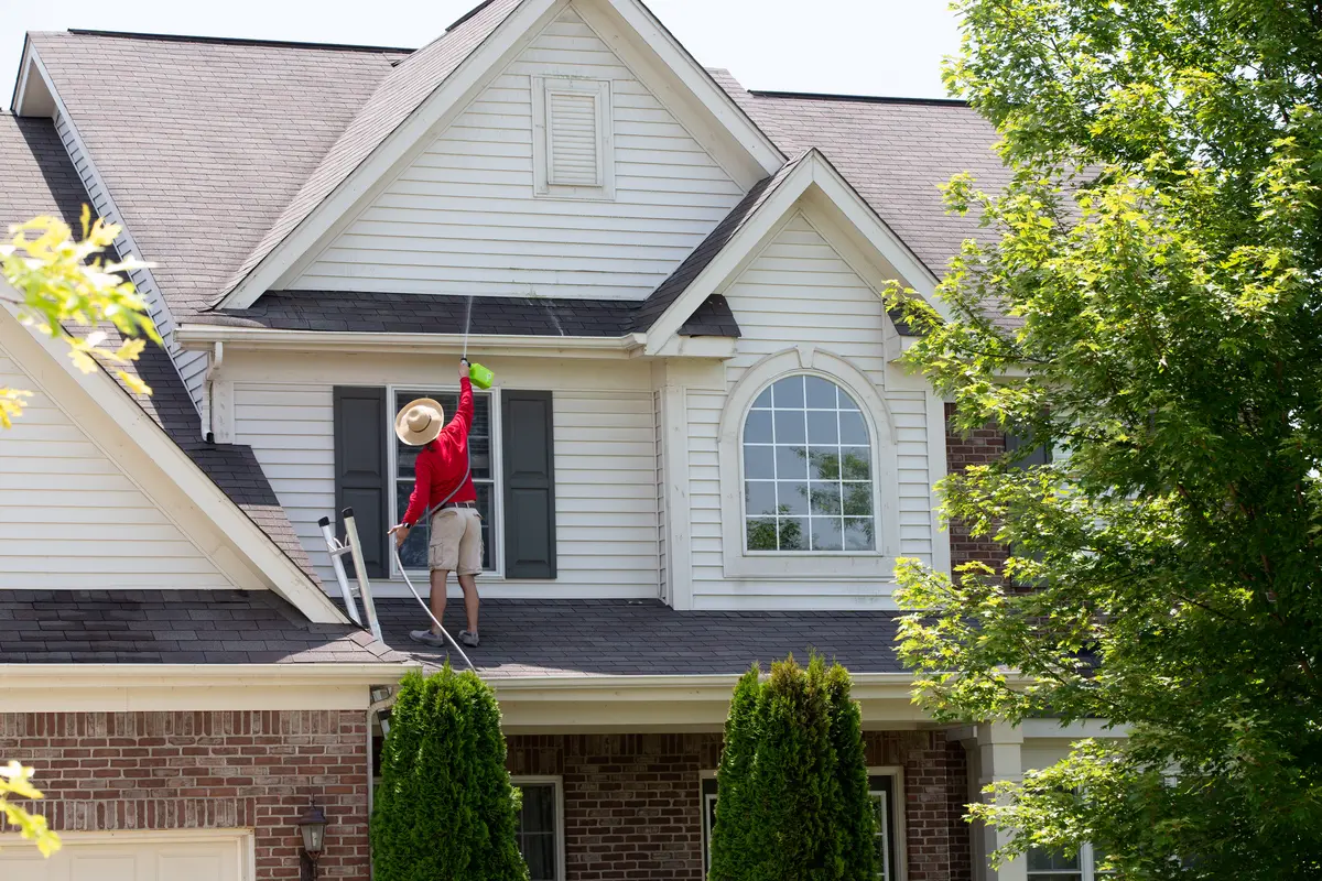 homeowner cleaning roof
