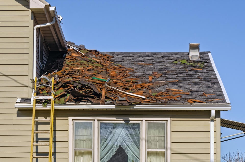 roof tear off-old roofing materials being removed from a shingle roof