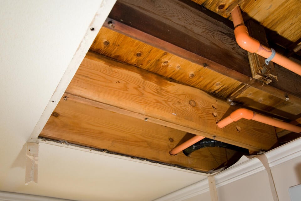 water leaking from ceiling-part of ceiling removed to expose water leak in roofing