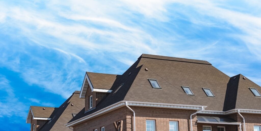 Dutch gable roof in front of blue sky