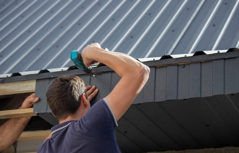 Man Installing METAL Roof Panels with a Drill.
